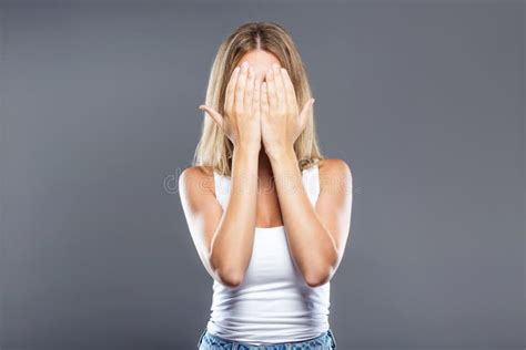 Beautiful Young Woman Covering Her Face Over Gray Background Stock