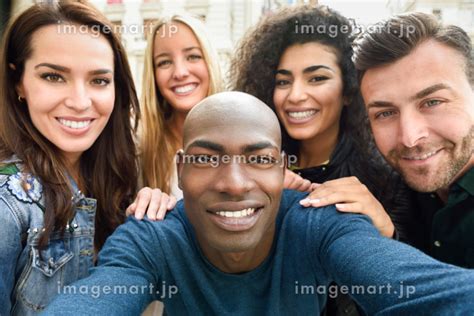 Multiracial Group Of Friends Taking Selfie In A Urban Street With A