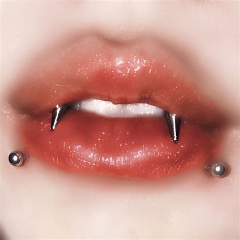 A Woman S Lips With Piercings On Them