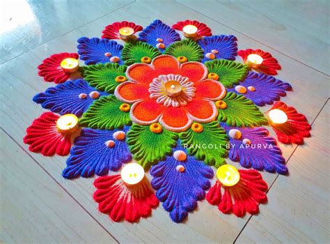 a colorful flower design with candles on the floor