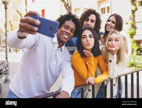 Multi Ethnic Group Of Friends Taking A Selfie In The Street With A