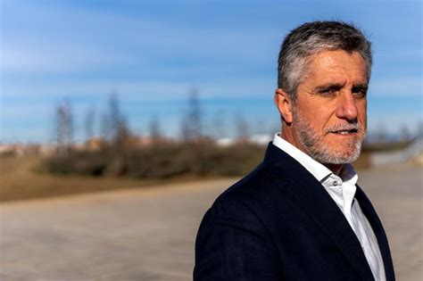 Premium Photo Thoughtful Senior Man Looking At Camera On Street