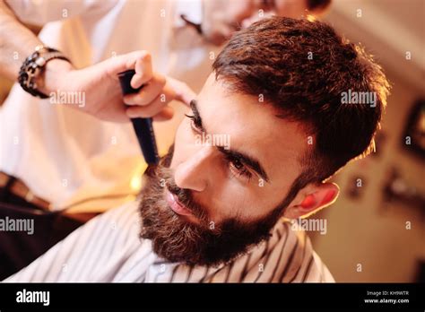 Hairdresser Or Barber Does A Hairstyle To The Client Stock Photo Alamy