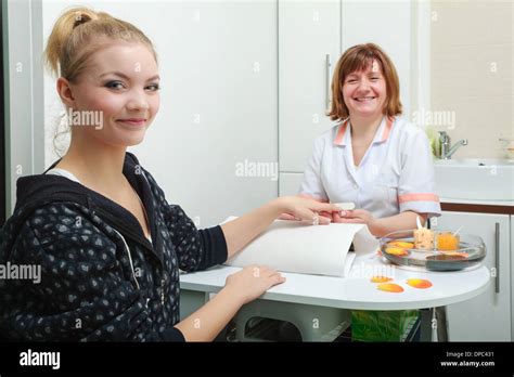 Beautician With File Filing Nails Female Client Woman Spa Beauty Salon