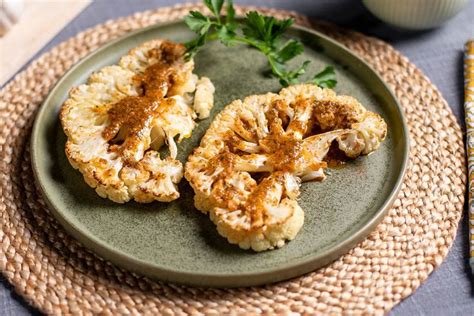 Two Pieces Of Cauliflower On A Green Plate