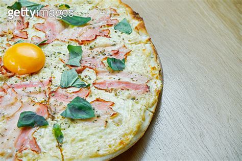 Italian Homemade Carbonara Pizza With Mozarella Cheese Yolk And Bacon