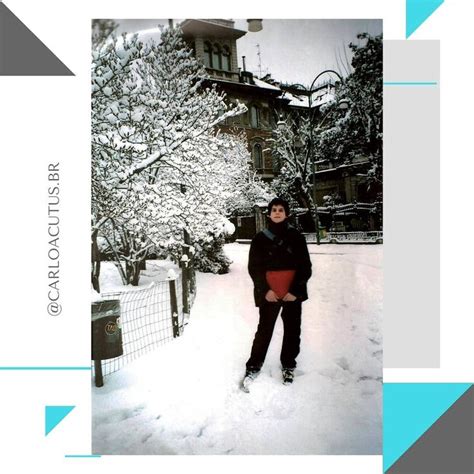 A Woman Standing In The Snow Next To A Fence And Tree With Snow On It