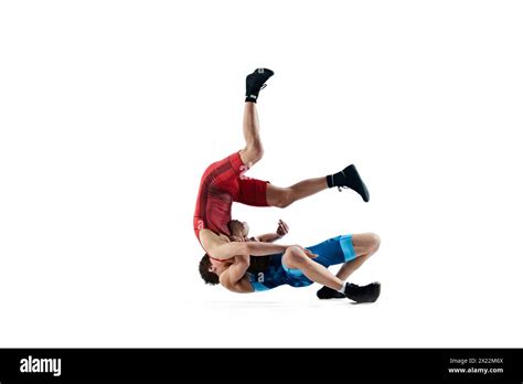 Young Men Athletes Engaged In Challenging Wrestling Match