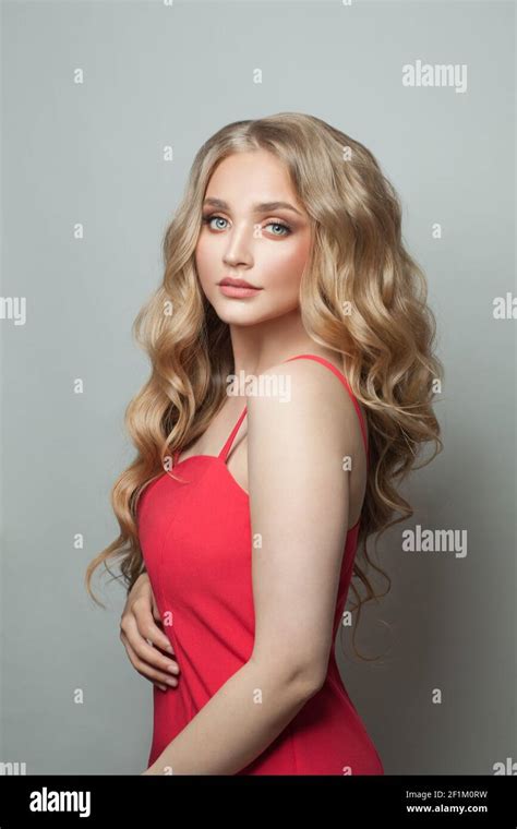 Pretty Woman Blonde Fashion Model In Red Dress On White Background