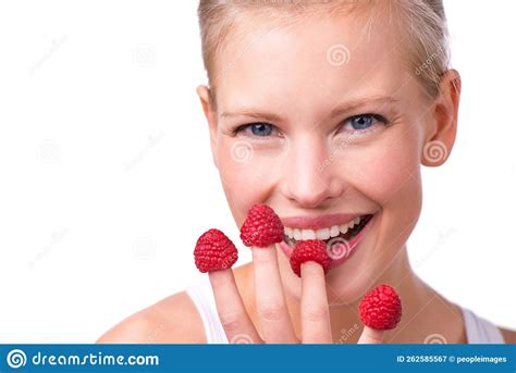 Finger Food Fun A Beautiful Young Woman Playfully Eating Raspberries Off Her Fingertips Stock