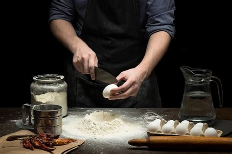 Premium Photo Hands Are Cracking An Egg Into Flour To Make Dough On