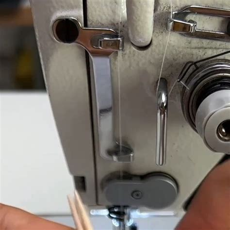 Someone Is Working On A Sewing Machine With Needles In Front Of The