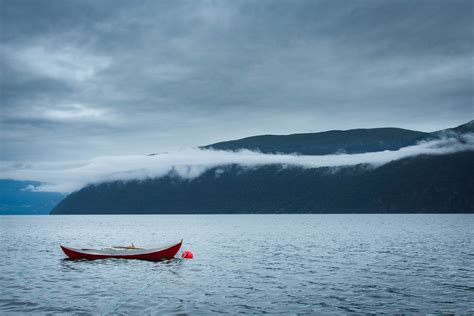 Brown Boat In Body Of Water Against Mountain Hill Hd Wallpaper