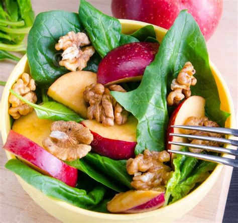 The Spinach Salad With Nuts And Apples Served On Table Spinach Salad With Nuts And Apples Served ...