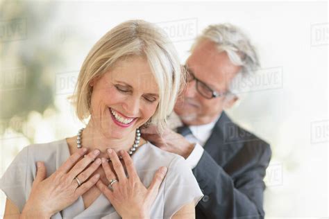 Smiling Older Caucasian Man Giving Wife A Necklace Stock Photo Dissolve