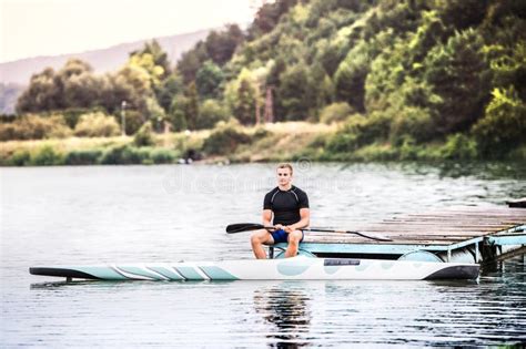 Canoeist Man Sitting In Canoe Paddling In Water Concept Of Canoeing