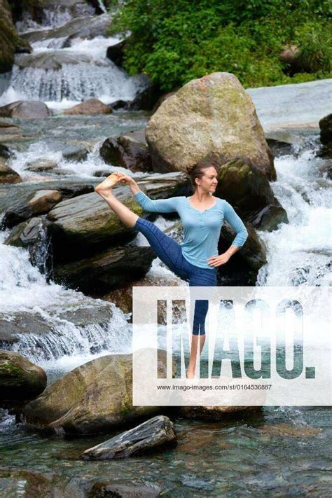 Woman Doing Ashtanga Vinyasa Yoga Asana Outdoors At Waterfall Yoga