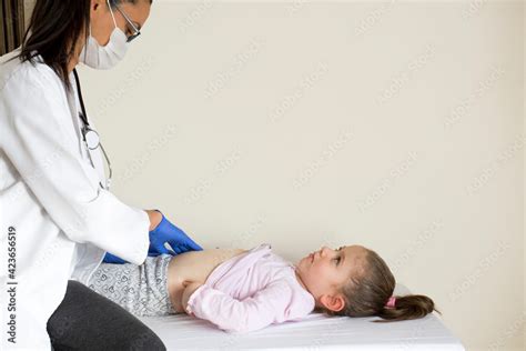 Chubby Little Girl In Pediatric Examination By Her Doctor Doctor