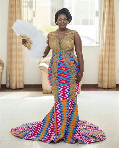 A Woman In A Colorful Dress Holding A Fan