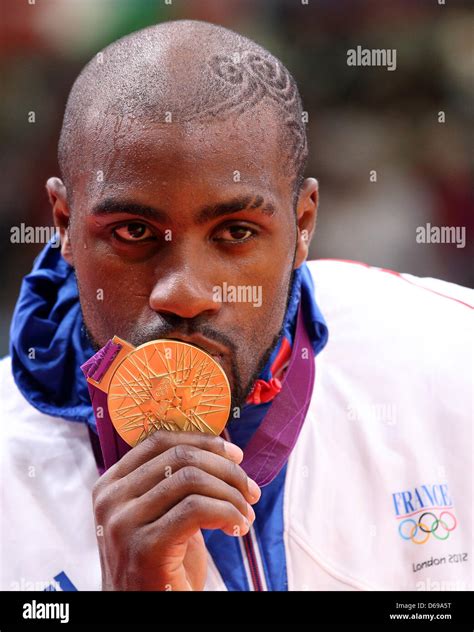 Gold medal winner Teddy Riner of France celebrates with his gold medal ...