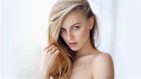 Download Radiant Blonde Woman With Captivating Eyes Wallpaper