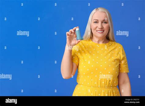 Mature Woman With Inhaler On Color Background Stock Photo Alamy