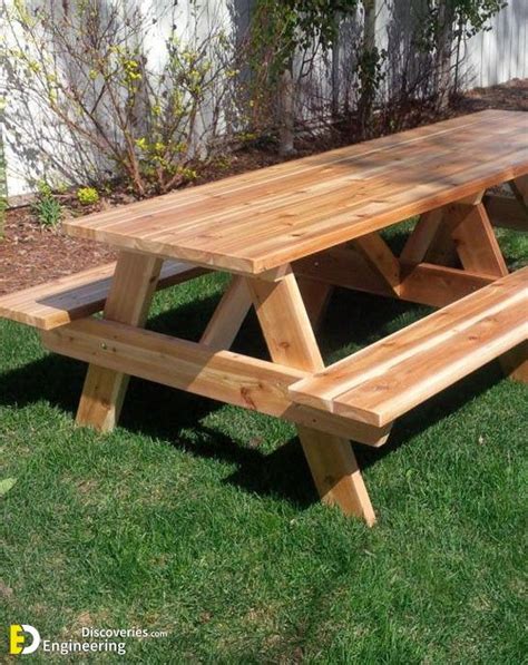 A Wooden Picnic Table Sitting In The Grass