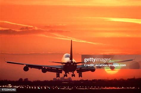 Boeing 747 Landing On The Runway At Sunset With Runway Lights On And