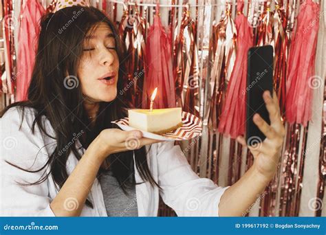 Happy Woman Making A Wish And Blowing Candle On Birthday Cake And