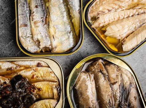 Premium Photo Assorted Canned Fish In A Tin Over Gray Concrete