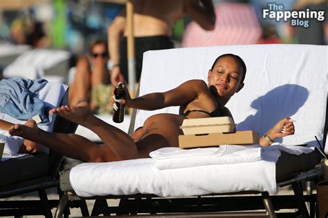 Karrueche Tran Wears A Black Bikini As She Tops Up Her Tan On The