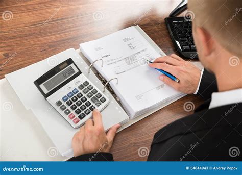 Businessman Calculating Invoice At Desk In Office Stock Image Image