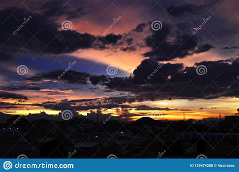 Dramatic clouds and sunset stock image. Image of black - 129474255