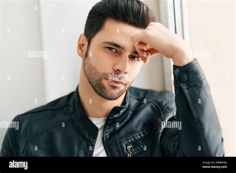 Closeup Portrait Of Handsome Thoughtful Man Posing On White Studio