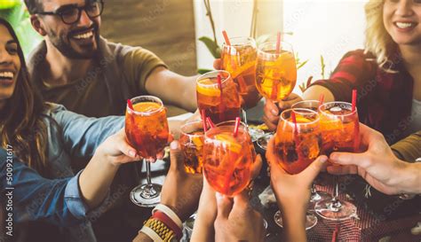 Happy Friends Cheering Drinks Glasses In Bar Restaurant Young People