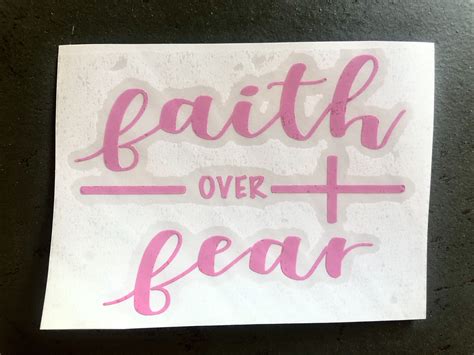 A Sticker With The Words Faith Over Fear Written In Pink Ink On White Paper