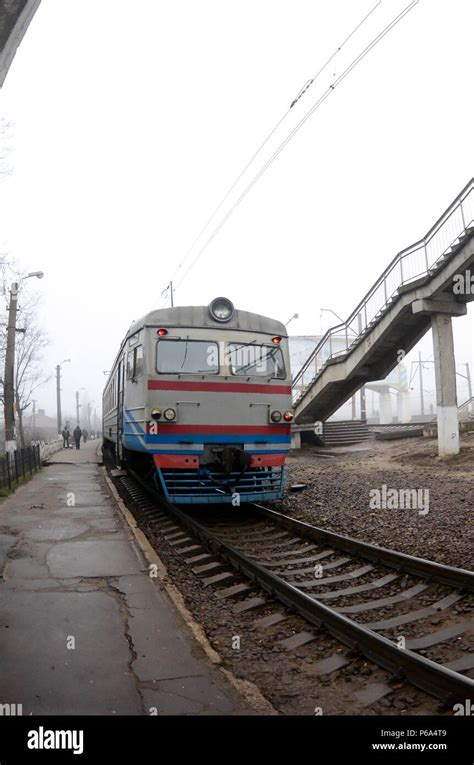 The railway track in a misty morning. The Ukrainian suburban train is ...