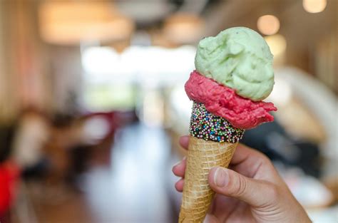 Foto De Primer Plano De Una Persona Sosteniendo Un Helado De Sabores