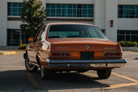 A White Car Parked In A Parking Lot Premium Ai Generated Image