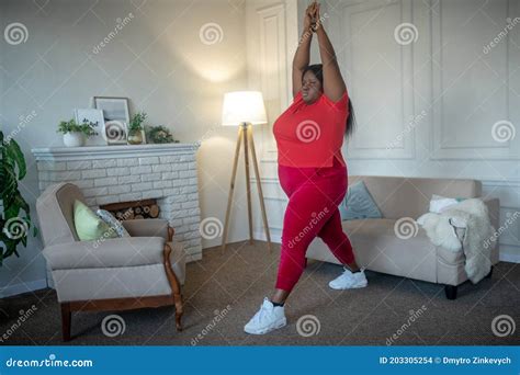 Plus Size African American Woman Doing Gymnastics At Home Stock Photo