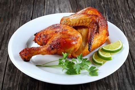 Premium Photo | Half of grilled chicken on a plate