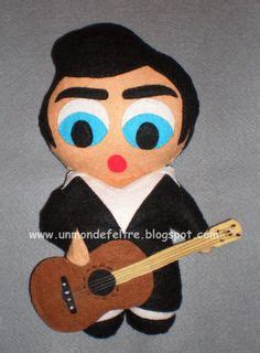 A Stuffed Toy With A Guitar In His Hand