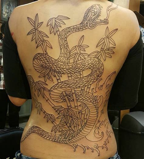 The Back Of A Woman S Body With A Tattoo Design On Her Lower Back