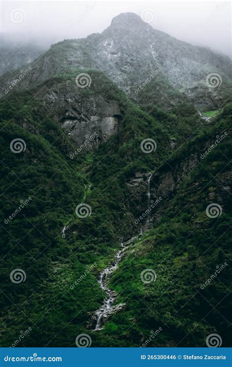 Moody Landscape With A Waterfall Falling On The Naeroyfjord In