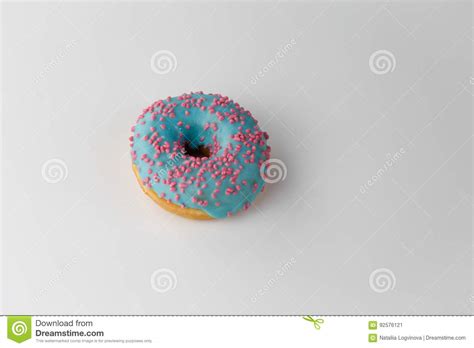 Donut With Blue Glaze And Pink Sprinkles On White Background Top View