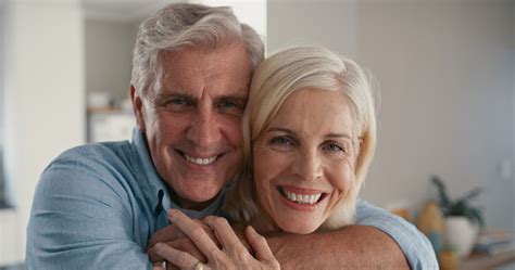 Shot Of A Mature Couple Standing Together With Their Arms Around Each