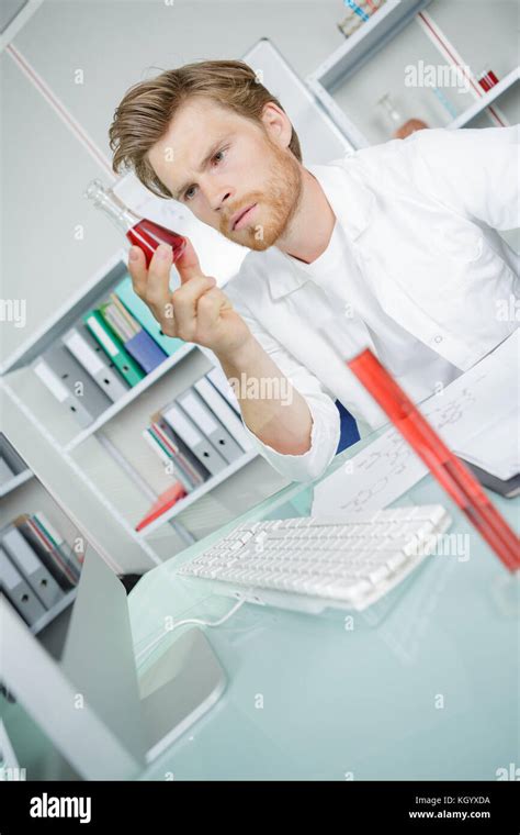 Male Technician Analyzing Blood Sample In Medical Laboratory Stock