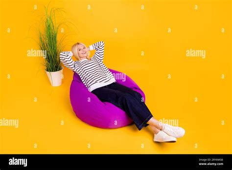 Photo Of Positive Mature Lady Sitting Comfy Chair Enjoy Relax Isolated