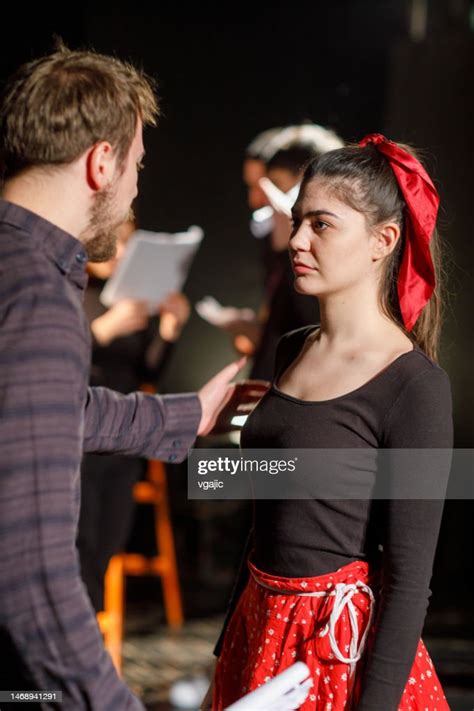 Actors Rehearsing With Scripts On Stage In Theatre High Res Stock Photo