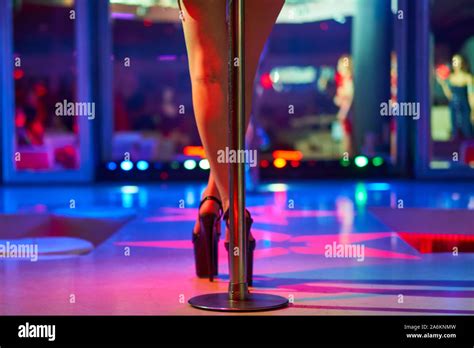 Heels Of Sexy Woman Pole Dancing Or Striptease Pylon In Night Club